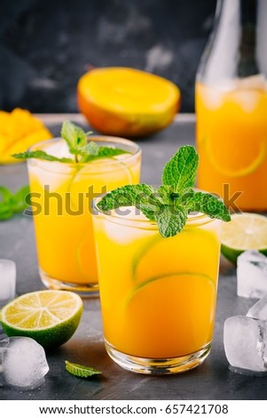 Fresh summer cold mango cocktail with lime and mint
