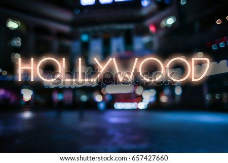 Inscription HOLLYWOOD on blurred city lights background. Travel USA concept