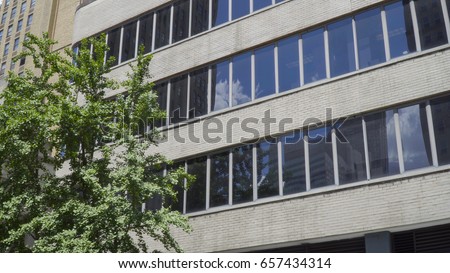 Generic office building exterior establishing shot photo. Day time outside New York City style facade DX