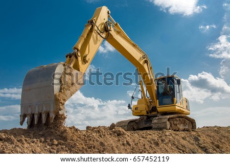 excavator blue sky heavy machine construction site   Royalty-Free Stock Photo #657452119