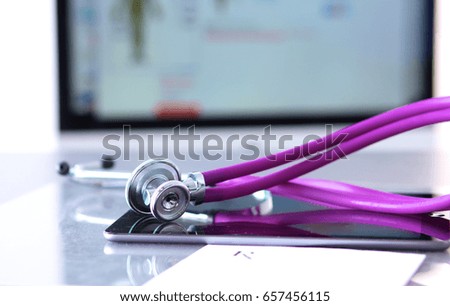Stethoscope with a tablet computer lie on a table