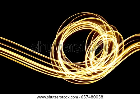 Gold, Yellow Light Painting Photography, parallel lines pattern against a clean black background