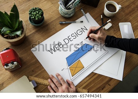 Hands working on billboard network graphic overlay on table