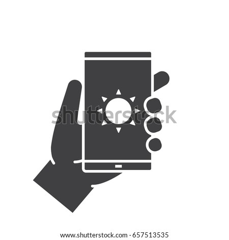 Hand holding smartphone glyph icon. Silhouette symbol. Smart phone solar charging. Negative space. Vector isolated illustration