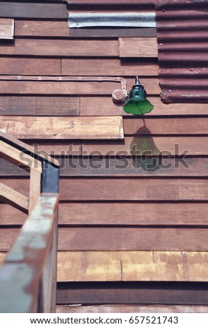 old style wooden wall with wall lamp, filter effect, vintage tone