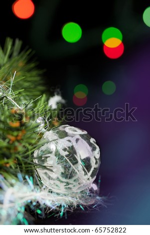 Transparent christmas ball with a christmas tree on the black background