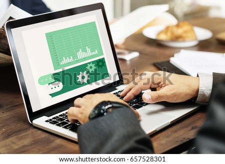 Hands working on laptop network graphic overlay