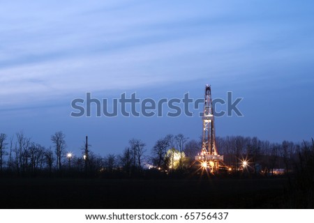 Oil well at night, lighting the outdoors.