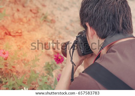 Smooth, Vintage a man hold digital camera and blurred nature background.
