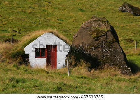 Little white elf house with turf roof and a mossy stone in Iceland Royalty-Free Stock Photo #657593785