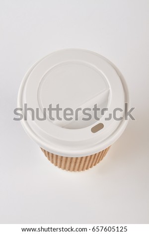 Disposable coffee cup, top view. Paper cup isolated on white.