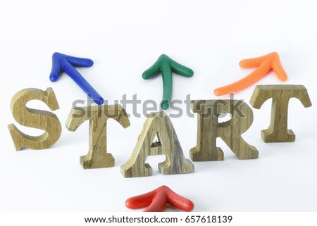 Business startup concept, wooden word of start with colorful arrow on white background