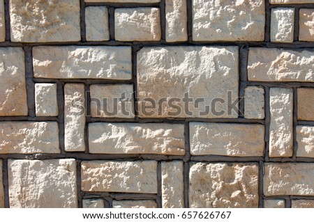 Texture, background, pattern. A wall made of natural sandstone. Wall of slate as texture background.marble texture decorative brick, wall tiles made of natural stone.