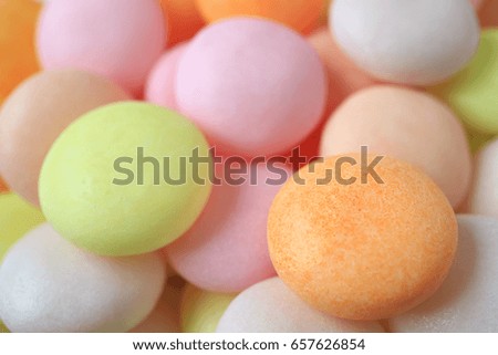 Closed up heap of pastel colored round shaped candy, for background with selective focus 
