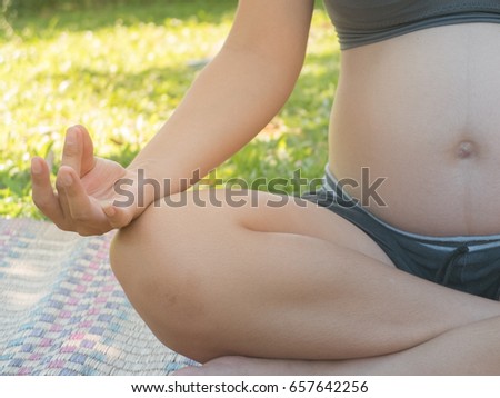 The pregnant woman is relaxing in the garden.