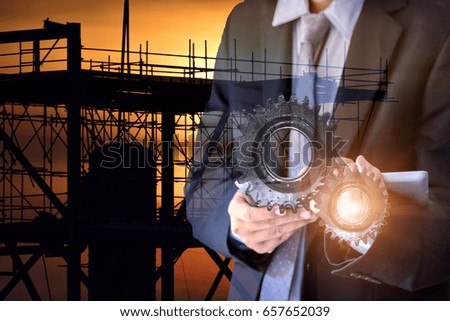Double exposure of success young businessman working on digital tablet and Gear, machine ,maintenance at industry concept .