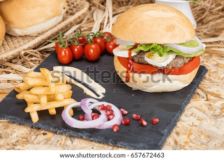 Sandwich with salad, meat, potatoes, ketchup, cheese, onion