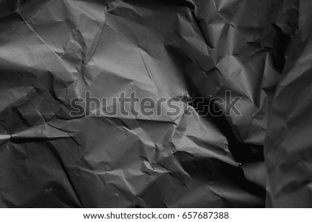 black paper texture. wrinkled paper. Wallpaper for your desktop and label in different font. textured surface. debris in an abandoned building. big crumpled banner