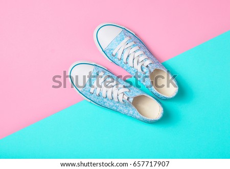 Sneakers lie on a multi-colored pastel surface. Top view. Fashion 90s
 Royalty-Free Stock Photo #657717907