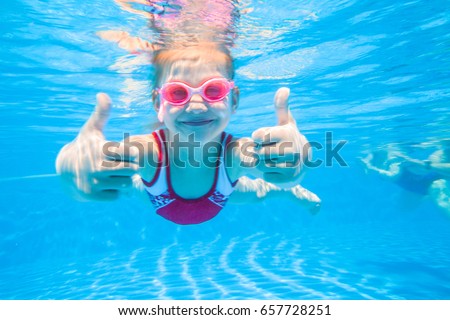 little girl deftly swim underwater in pool Royalty-Free Stock Photo #657728251