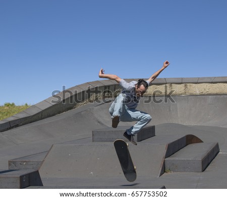 A skateboarder executing a kickflip  in the air