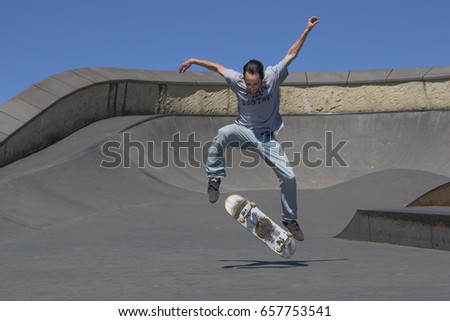 A skateboarder executing a kickflip in the air