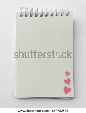 paper notebook with heart texture on white background.