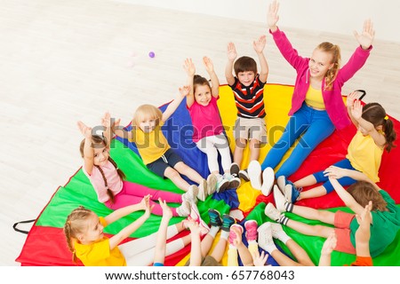 Happy teacher playing circle games with children
