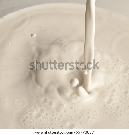 extreme closeup of pouring milk on a glass