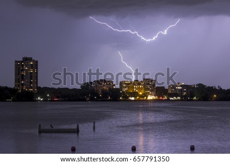 A Telephoto Shot of Bde Maka Ska, or Lake Calhoun, and South Minneapolis Residential Buildings as Lightning Strikes Twice