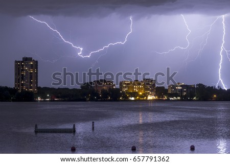 A Close Up on Buildings in South Minneapolis along Bde Maka Ska, or Lake Calhoun, as Multiple Lightning Bolts Strike during a Summer Storm