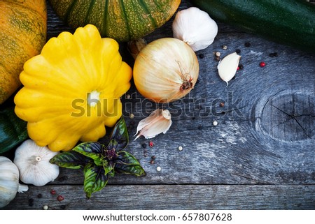 Gardening organic vegetables in assortment, buttercup squash, pumpkin and spices on wooden rustic board, top view with copyspace