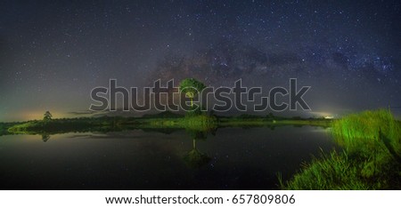 Beautiful landscape panorama of milky way with reflection at night