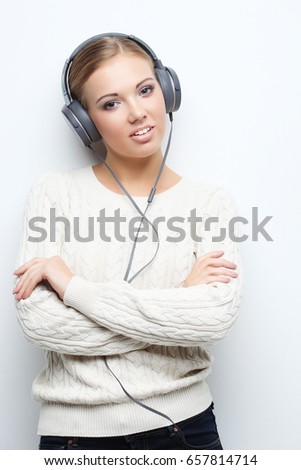 Music teenager girl dancing against white background.