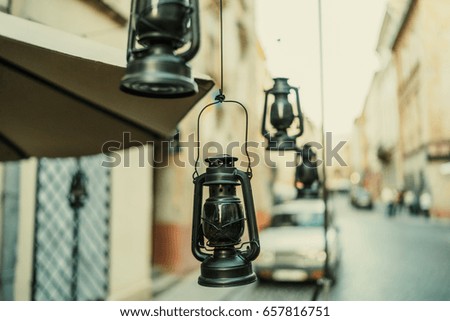 Vintage black kerosene oil lantern lamps. Terrace decor. Shallow focus. 