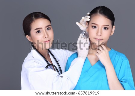 Beautiful Woman with Medical beauty Injection Treatment syringe over face before plastic surgery by doctor, Studio lighting white background isolated