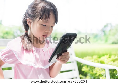 cute girl use phone in the park