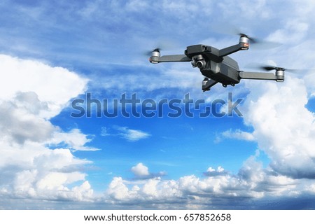 Drone flying in blue sky