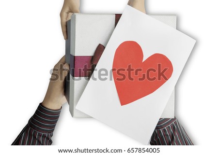Close up of daughter hands giving a gift and love card to father, isolated on white background 