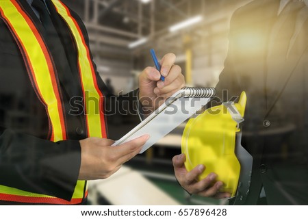 2 male occupational health and safety officer inside factory doing inspection Royalty-Free Stock Photo #657896428