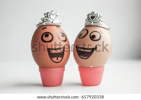 Struggle for the title of Miss Universe, city, state. Funny eggs with painted face concept. On white photo. electronic. Photo for your design