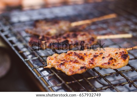 Asian grilled pork, Thai food / Thai Meat Balls and pork in grilling process / soft focus picture 