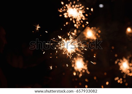 Picture showing group of friends having fun with sparklers.