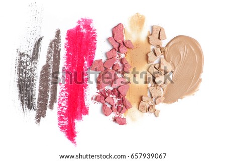 Set of crashed face powder, blushers, smudged concealer, corrector, lipstick, pencils and mascara isolated on white background. Top view point.
