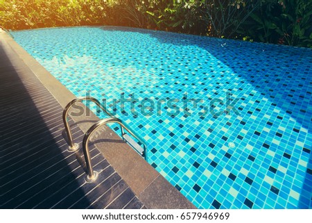 blue swimming pool around with green nature garden, place of outdoor activity relaxation in summer day, image used sunlight vintage filter effect
