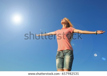 Young beautiful woman enjoying sunlight outdoor