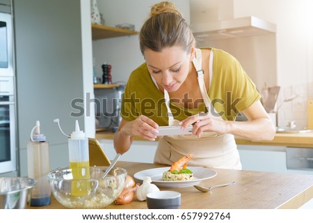 Blogger taking picture of dish to upload on website