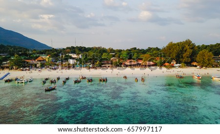 Aerial view over group of long tail boats with beautiful sea and beach,Top view from drone, Koh Lipe island, Satun,Thailand.