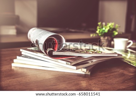 selective focus of the stacking magazine place on table in living room Royalty-Free Stock Photo #658011541