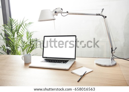 A notebook with coffee cup, note, stand on the wood desk at the office.